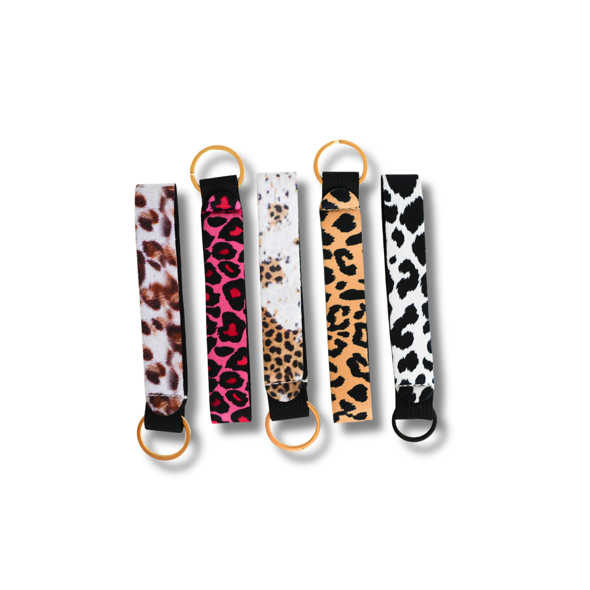 Five animal print keychains with gold rings on a white background