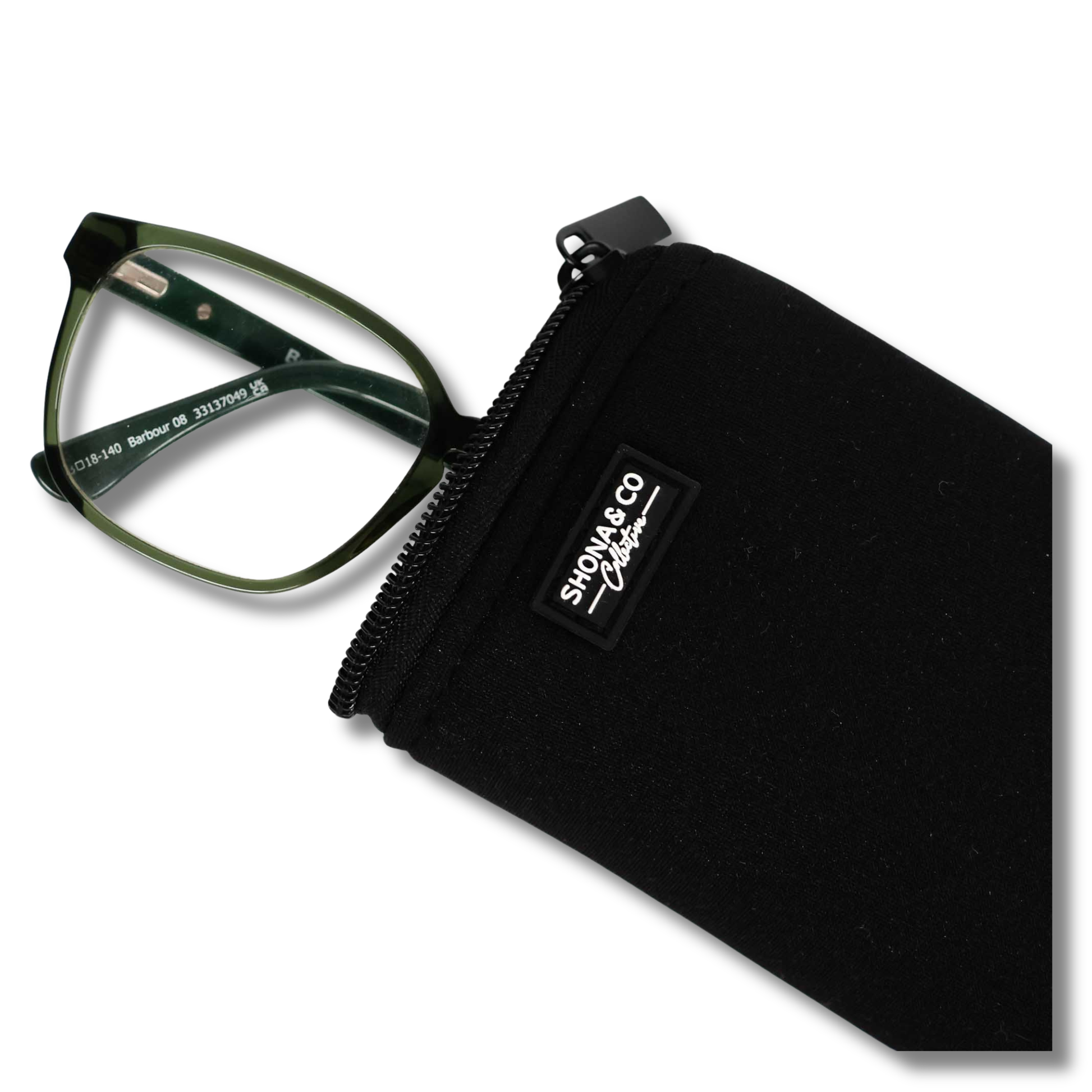 Green eyeglasses in a black case with 'Shonda & Co' branding on a white background